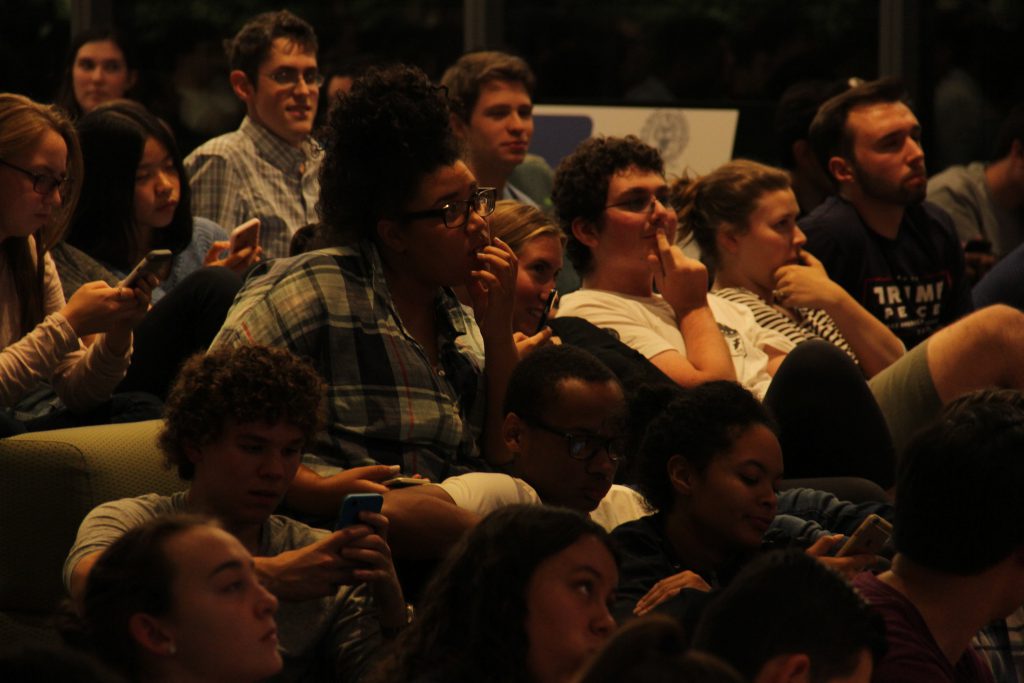Intrigued students watch carefully at a debate watch party in Washington DC.