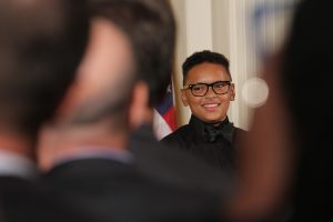 Maxwell Fairman looks over at Michelle Obama after performing at the ceremony as part of the Perfect Fourth String Quartet. "Anyone who still doubts the power of the arts to transform students lives," Obama said. "I urge you to find one of these students and talk to them." (Kelly Norris/MNS).
