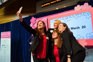 National Cherry Blossom Festival staff members take selfies onstage after the press conference. (Rhytha Zahid Hejaze/MNS)