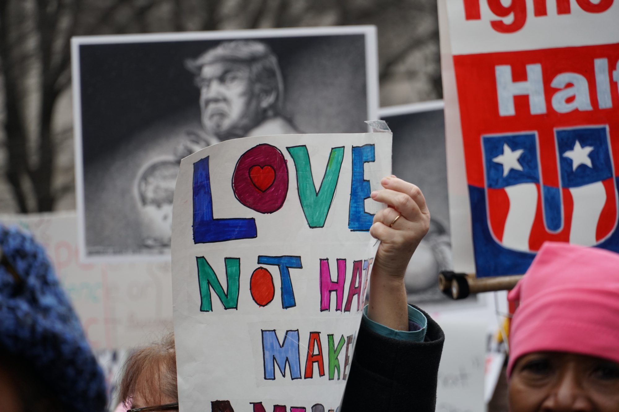 Marchers held up signs with anti-Trump and female empowerment messages. (Ester Wells/MNS)