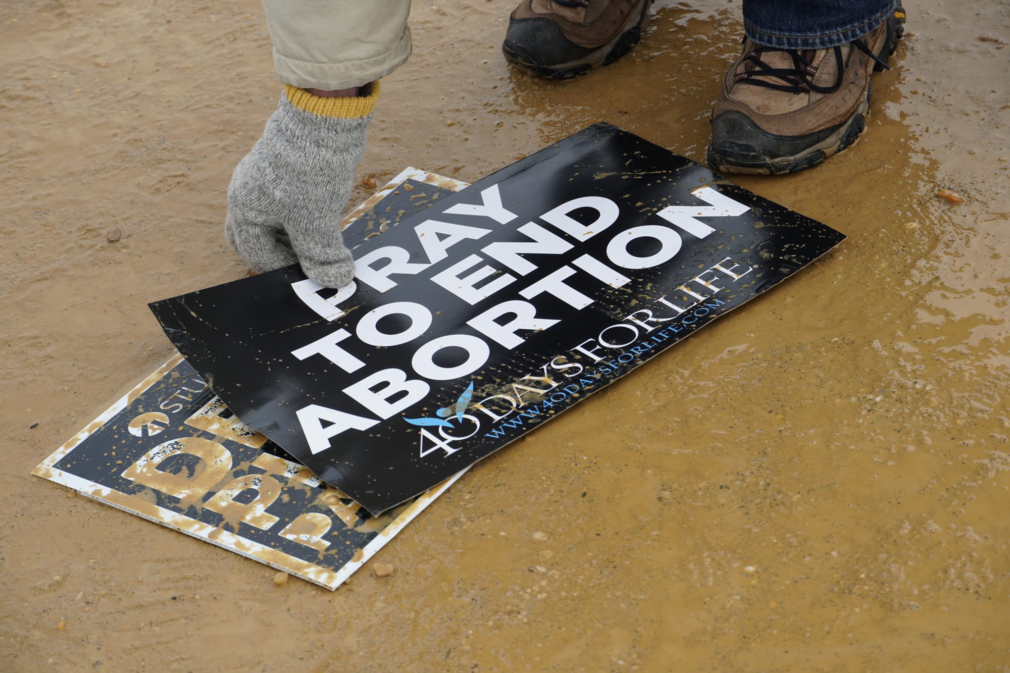 After the march, volunteers picked up anti-abortion signs that were dropped. (Ester Wells/MNS)
