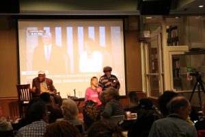 Co-founder of CODEPINK, Madea Benjamin addresses the crowd as other speakers converse with audience members. (Brooke Fowler/MNS)