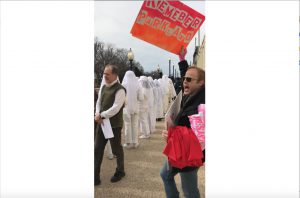 Sean Stefanic--who calls himself, a “fabulous footman” of Gays Against Guns--and other protesters march to lawmakers’ offices to demand stricter gun laws on the one year anniversary of the school shooting in Parkland, Fla. (Gabrielle Bienasz/MNS)