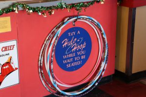 At the hostess station, diners can hula-hoop while waiting for a seat. The servers’ shirts have diner puns like “Give up carbs? Over my bread body.” (Charlotte Walsh/MNS)