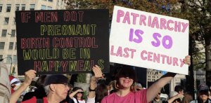 Marchers took photos of each other’s signs, many of which called for the expansion of reproductive rights. (Caroline Killilea/MNS)