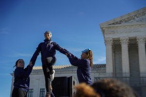 DC Cheer performed in front of the courthouse, carrying pink and blue pom poms in support of trans athletes. (Cayla Labgold-Carroll/MNS)