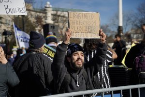 A man leans across the barricade arguing with other demonstrators. (Cayla Labgold-Carroll/MNS)