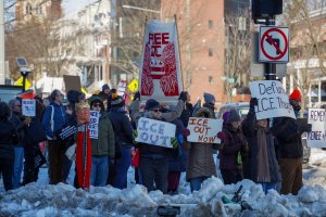 Protesters gathered outside of the Georgia Ave-Petworth Metro exit, standing on ice mounds left from the previous week's snowstorm. (Cayla Labgold-Carroll/MNS)