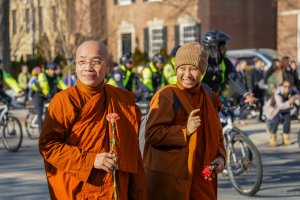Monks smiled at babies who greeted them down the row. (Cayla Labgold-Carroll/MNS)