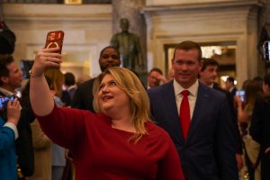 Rep. Kat Cammack, R-Colo., stops to take a selfie as she walks down the press aisle. (Cayla Labgold-Carroll/MNS)