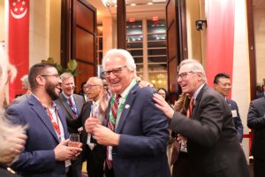 David Lesser, mayor of Manhattan Beach, celebrates after being selected in a lottery draw for a round‑trip flight from New York to Singapore. (Dasha Dubinina/MNS)