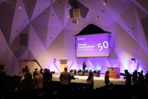 Attendees mill around the auditorium, chatting before the start of the second panel. (David Sun/MNS)