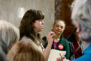 A Free DC organizer directs participants to senators’ and representatives’ offices, encouraging them to speak with staff about their opposition to the joint resolution changing the District’s tax law. (André Hiroki/MNS)