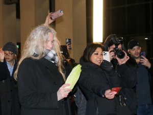 The lion dancers were “fed” lettuce by onlookers, a ritual that symbolizes blessing a business or home with wealth, luck and prosperity. (Melody Xu/Medill News Service)