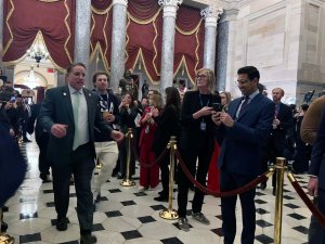 U.S. ice hockey player Charlie McAvoy held up his Olympic gold medal from the U.S. team's win against Canada Sunday. (Brooke Sharp/MNS)