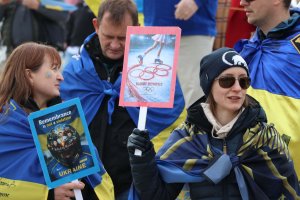 A protester held a sign that said, “Bloody Olympics,” referring to the International Olympic Committee’s 2022 decision to ban Russia from participating in the Olympics after the invasion. (Sarah Han/MNS)