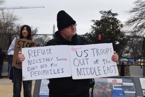 One protester held a sign that said “Don’t die for pedophiles,” urging U.S. military troops to refuse their service in the Middle East. (Brooke Sharp/MNS)