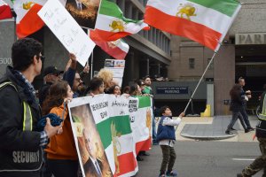 A young boy twirled the Iranian flag in front of the anti-regime crowd, as the other demonstrators cheered him on. (Brooke Sharp/MNS)