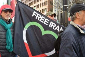 A participant holding a “Free Iran” banner, while protesters chanted “IRGC. Terrorist,” referring to the Islamic Revolutionary Guard Corps. (Brooke Sharp/MNS)