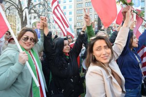 Women held hands at the rally, which was scheduled on the eve of International Women’s Day to honor the potential liberation of Iranian women, amid the war. (Brooke Sharp/MNS)