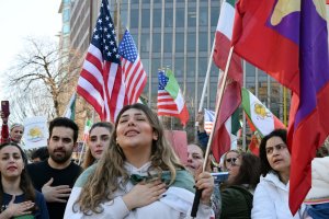 Participants placed their hands on their hearts during the Iranian national anthem, Mehr-e Khavaran, in Farragut Square. (Brooke Sharp/MNS)