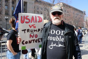 Several protesters held signs that denounced the Trump administration for breaking up federal agencies. (Sarah Han/MNS)